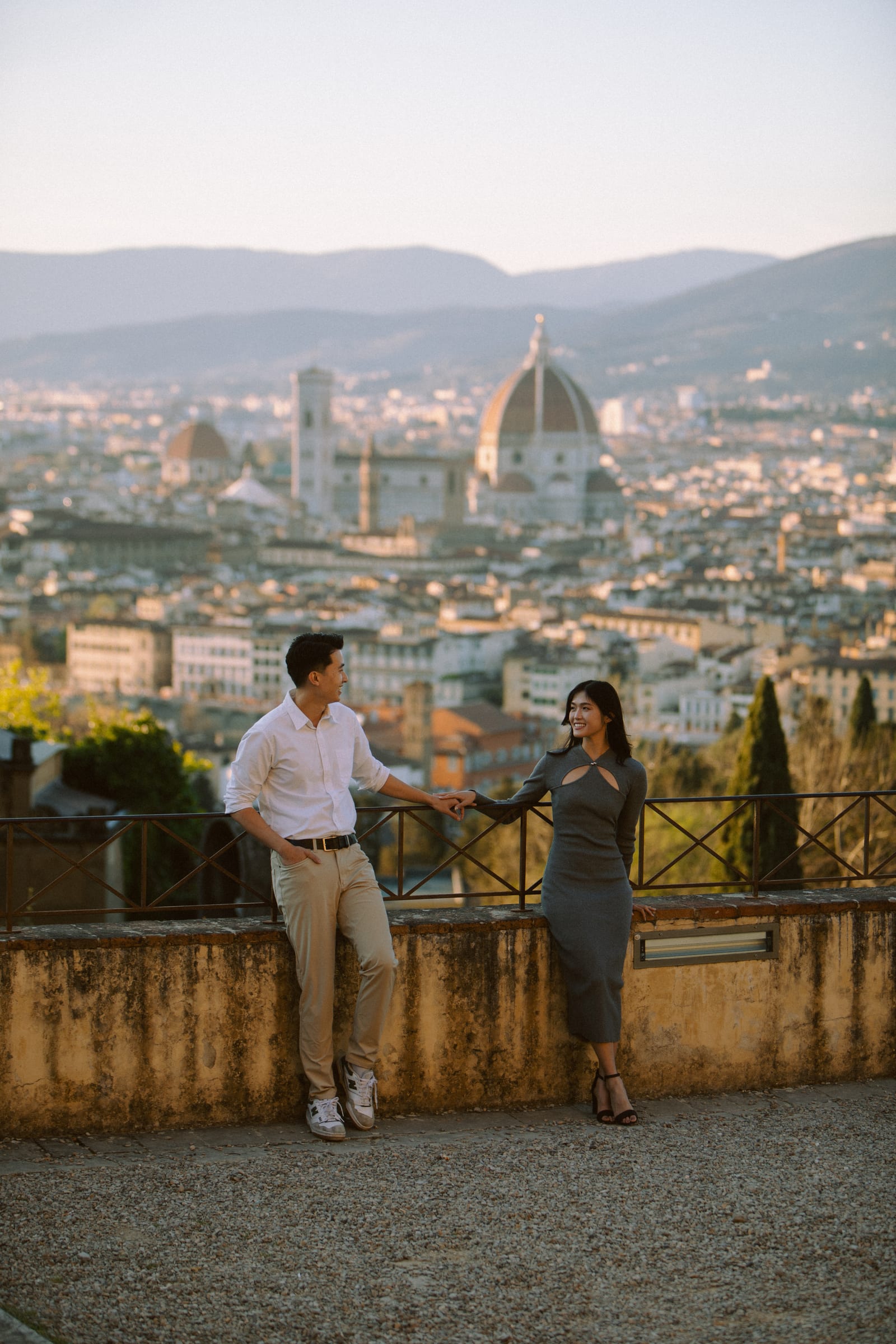 Couple posing at Piazzale Michelangelo with Florence and the Duomo behind them