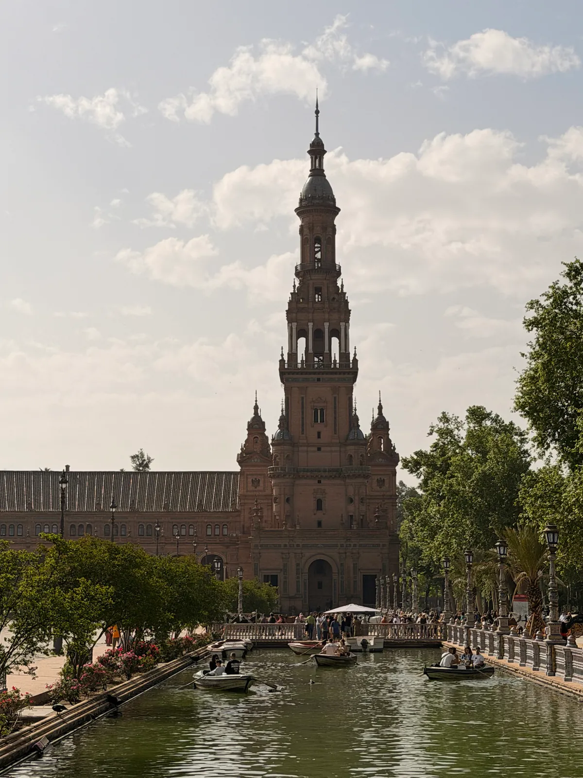 Rowboats on the canal below the tower at Plaza de España in Seville