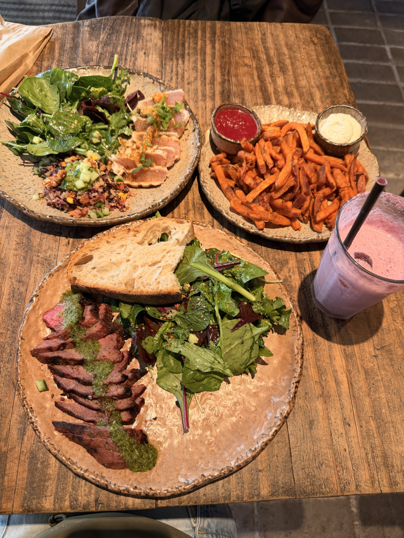 Honest Greens Madrid lunch spread with bowls, sweet potato fries, and drinks
