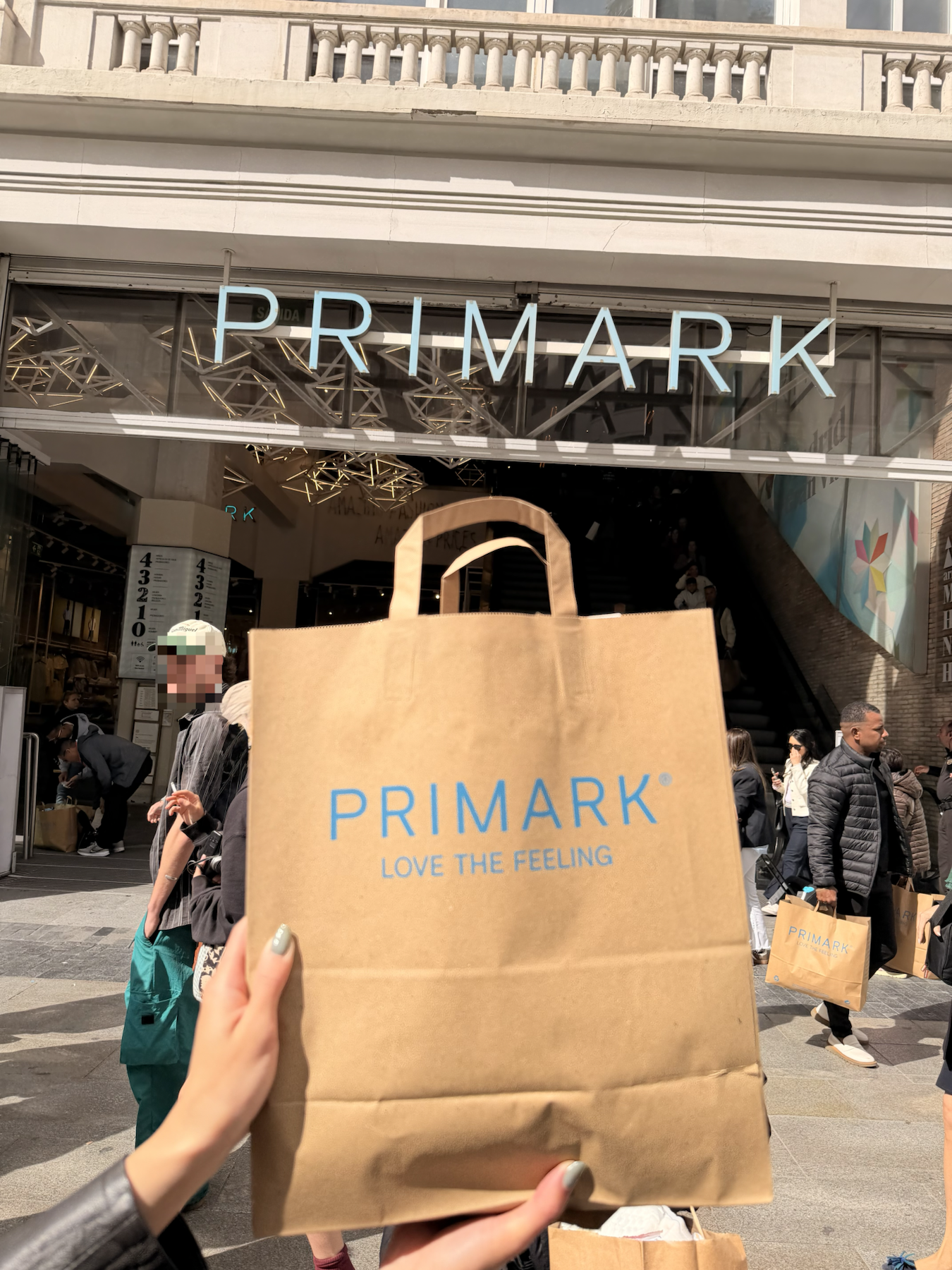 Primark shopping bag held outside the Primark flagship on Gran Via in Madrid