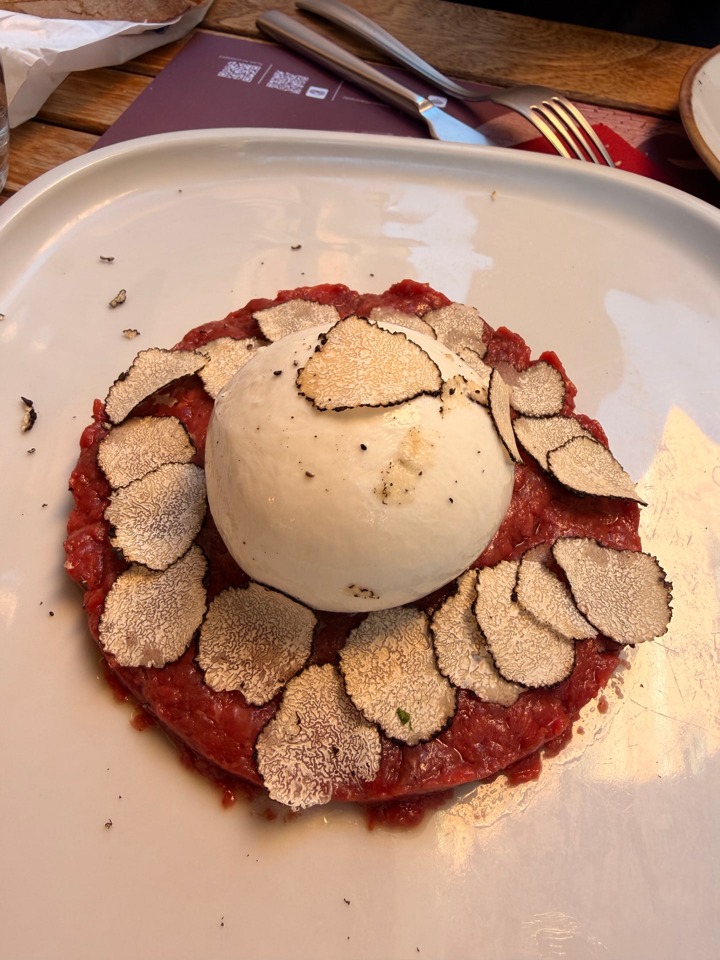 Burrata topped with sliced truffle at Benso Bistro in Rome