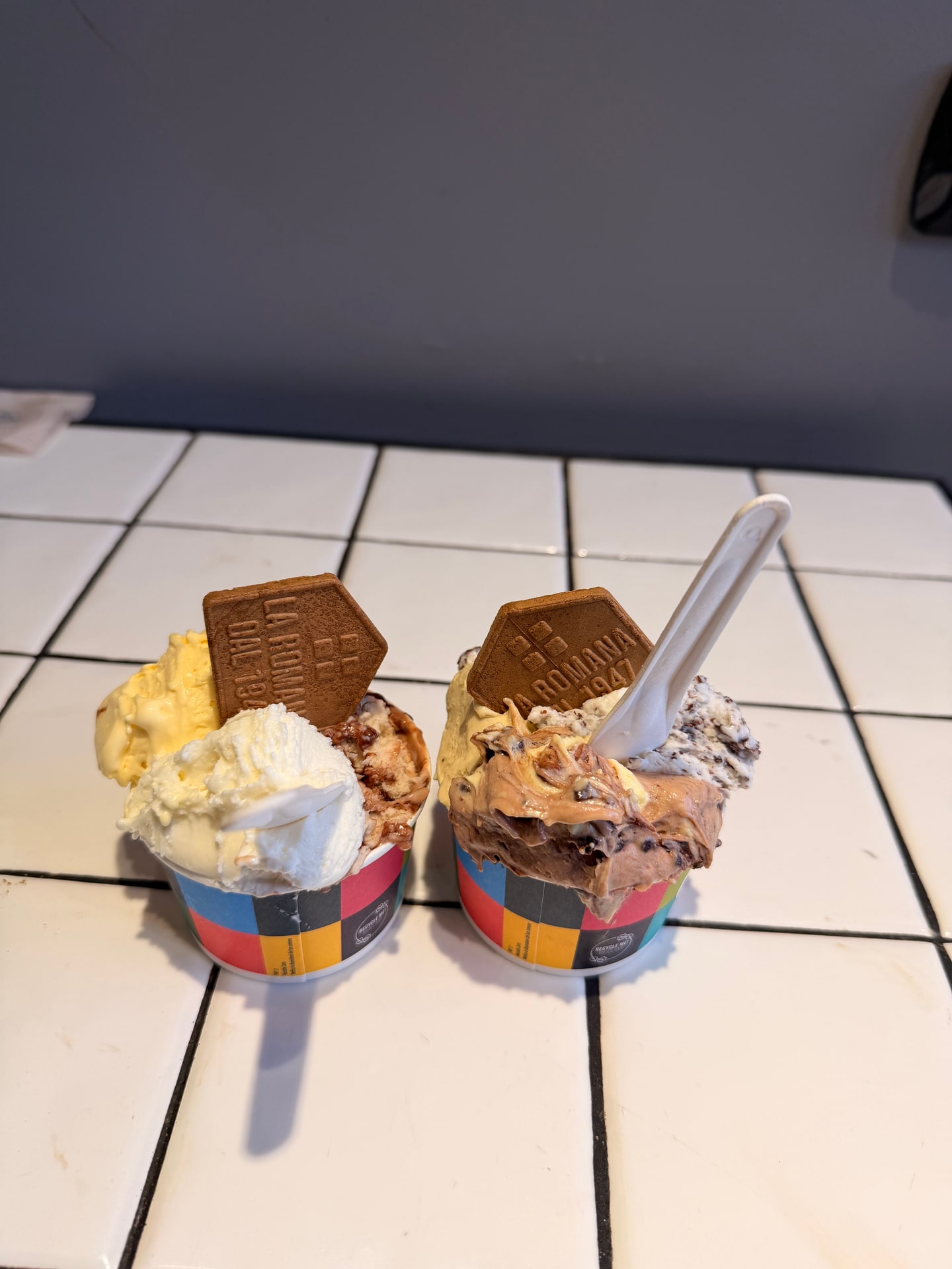 Two gelato cups topped with chocolate at Gelateria La Romana in Rome