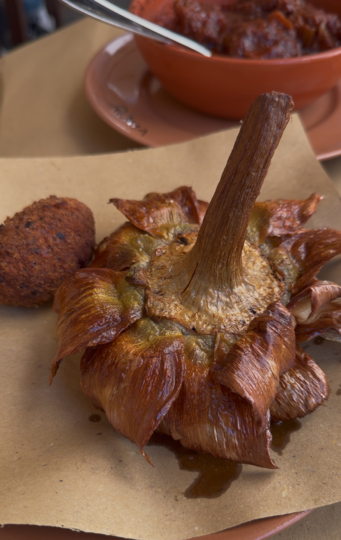Roman artichoke and suppli served at Osteria da Fortunata in Rome