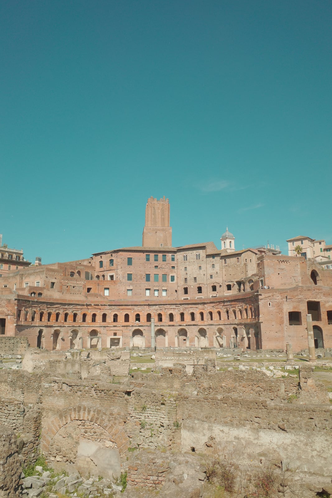 Wide vertical view across the Roman Forum ruins in Rome