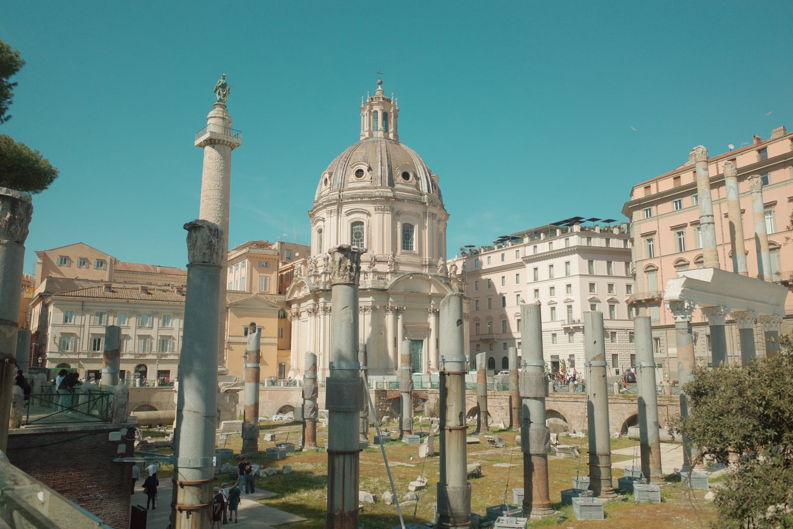Roman Forum columns with Trajans Column and a domed church beyond
