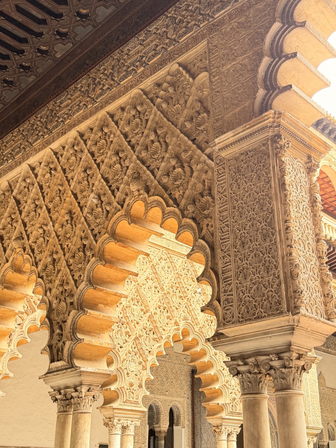 Mudéjar arches and carved plasterwork inside the Royal Alcázar of Seville