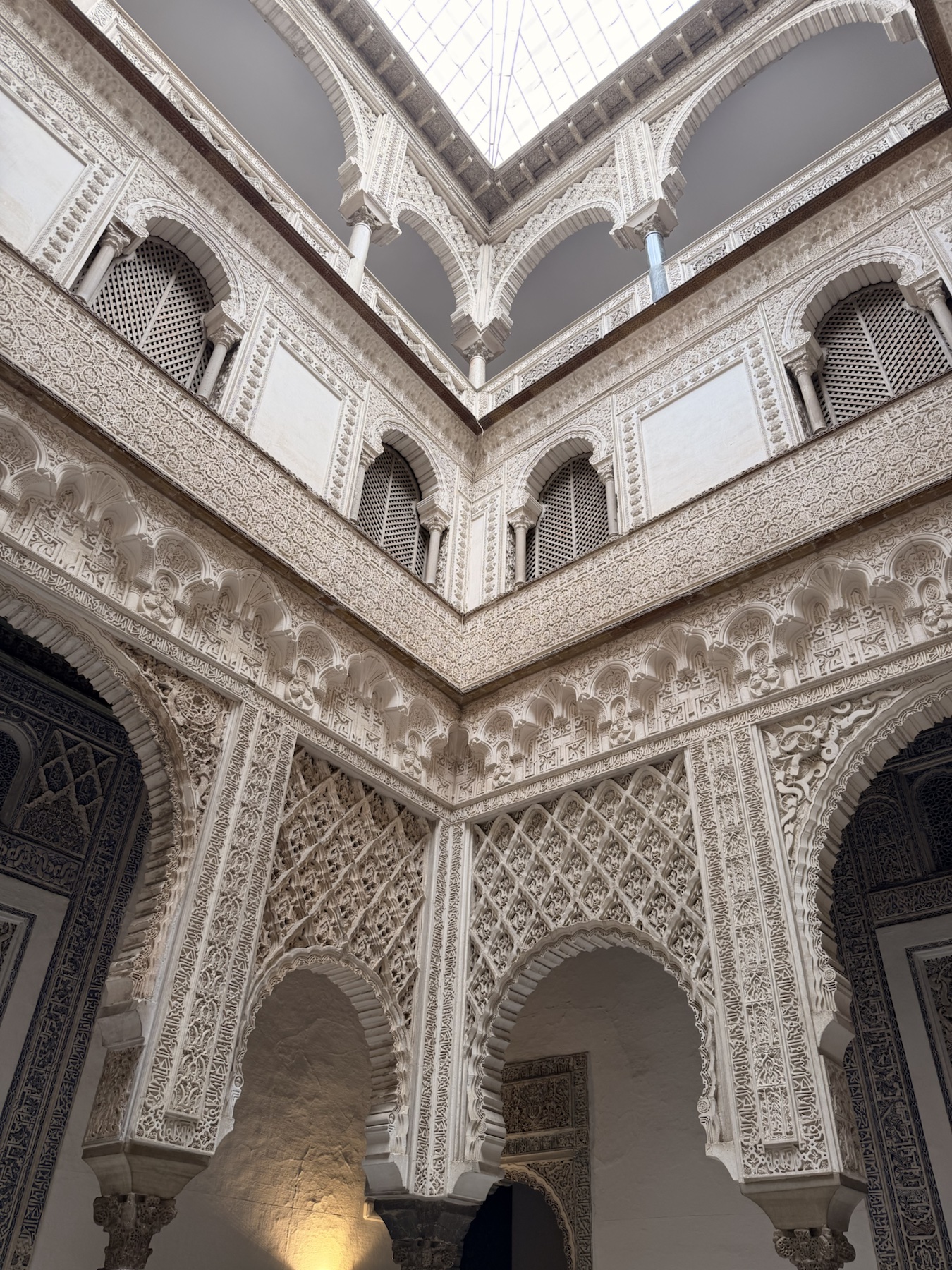 Detailed plasterwork courtyard inside the Royal Alcázar of Seville