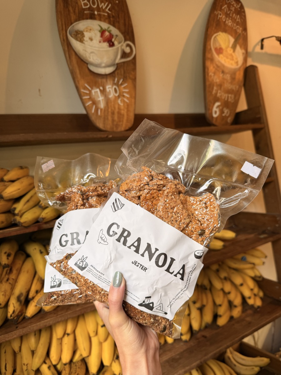 House granola packages at Jester, displayed in front of shelves of bananas