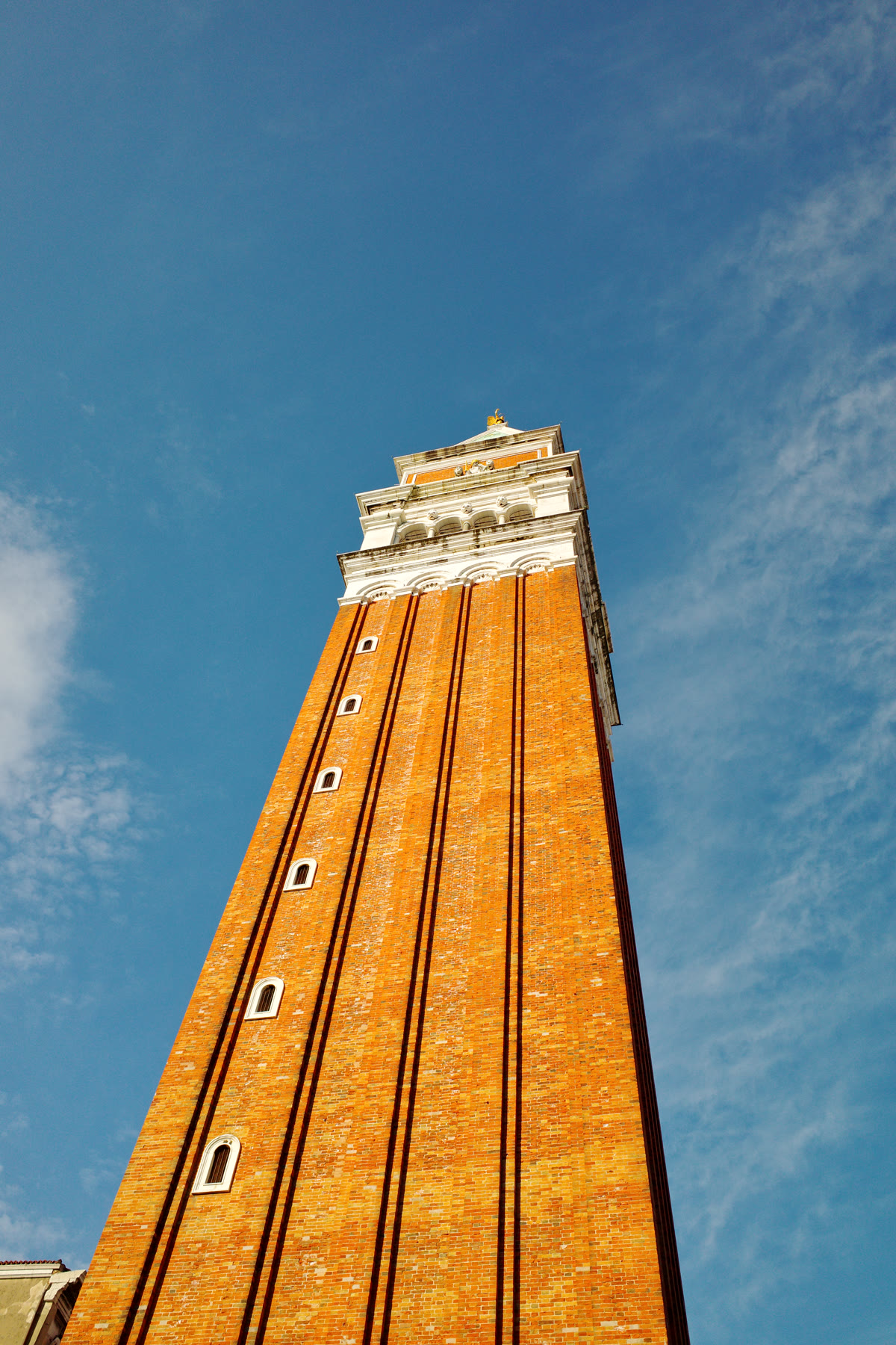 Close view looking up at St. Mark's Campanile against a blue sky