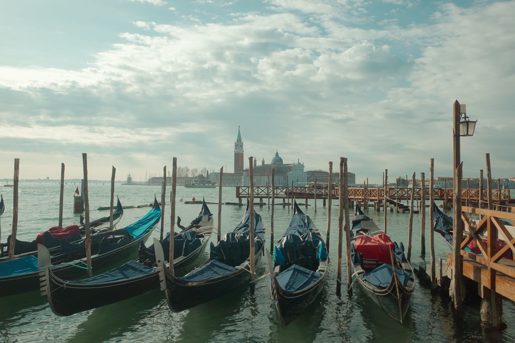 Venetian gondolas moored beside the lagoon near Piazza San Marco